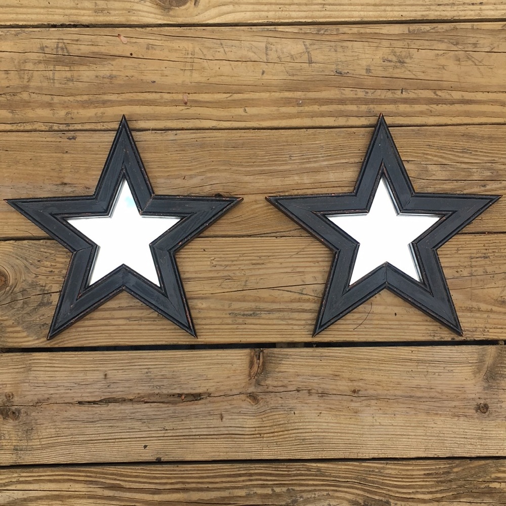 A pair of wooden star-shaped mirrors.